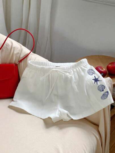 Comfortcana Short de style vintage décontracté avec imprimé d'éléments marins bleus, coquillages et étoiles de mer. Convient pour les festivals de musique, la plage, les vacances, les sorties d'été blanches. Tailles plus pour femmes avec liens à la taille.