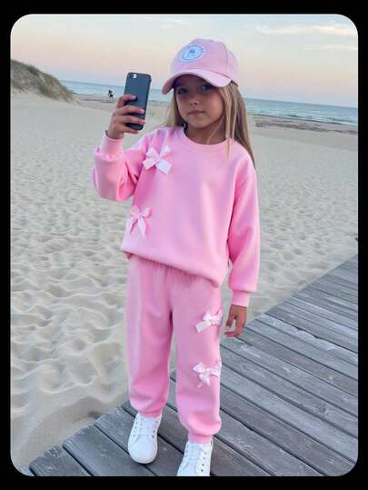 SHEIN Elladie kids 2pcs/Set Young Girls Fashion Pink Bow Round Neck Long Sleeve Sweatshirt And Elastic Waist Jogger Pants, Casual Sporty Outfit Suitable For Spring And Autumn Girls Jogging Set Girls Sweatsuit Set Girls Comfy Set Young Girl Sweatsuit Girls Bow Set Fall Winter