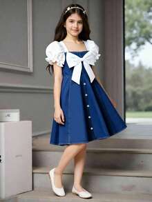 Elladie kids 少女春夏休闲时尚连衣裙，正面饰有白色蝴蝶结，前摆饰有白色金属珍珠纽扣，白色纯色梭织面料，短款泡泡袖拼接蓝色牛仔腰身，适合春夏返校季穿着，甜美可爱，尽显淑女风范，适合日常上学、外出、度假、拍照等春夏穿着。夏季服装，柔软舒适，充满海岛风情，适合海滩周末度假。少女服装，可爱连衣裙。 - 中等水洗藍 - 查看 11