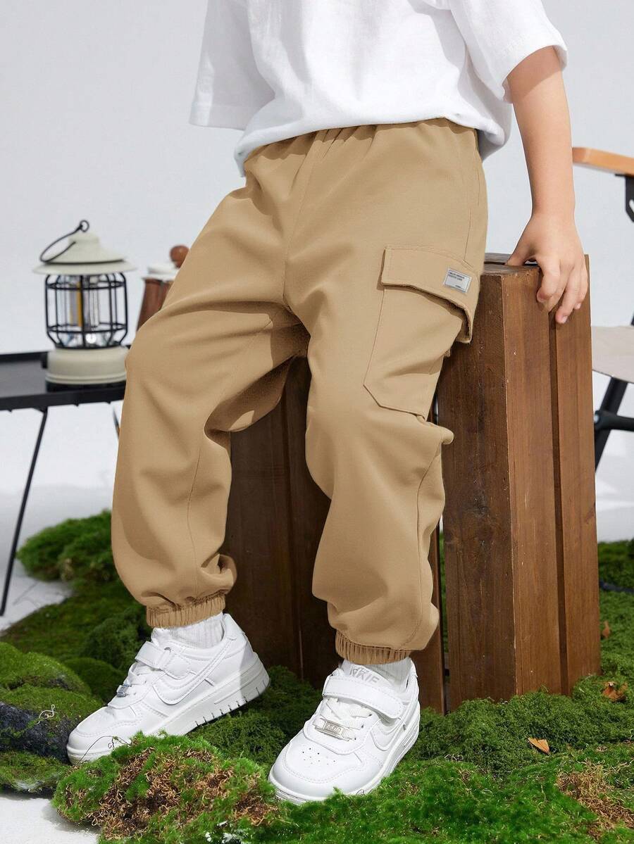 SHEIN Kids/Tween Boys' Khaki Summer Casual School Cargo Pants,Sports Graphic Print Patch Pocket Loose Tapered Solid Color Trousers,Daily Vacation Outfits - Khaki - View 1