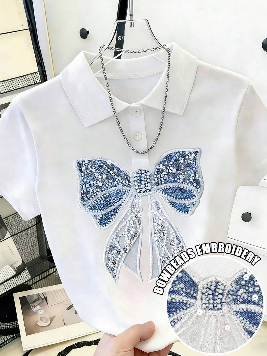 Áo thun nữ tay ngắn cổ tròn, dáng casual, in hình nơ và đính ngọc trai. - Nhiều màu - Xem 1