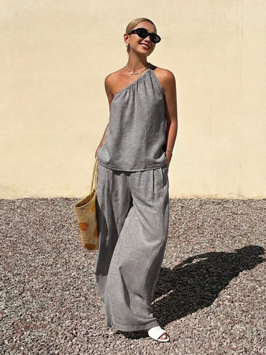 Livesso Bộ đồ thời trang xuân hè gồm áo ngắn tay lệch vai màu xám và quần ống rộng dáng suông, thích hợp cho công sở, đi nghỉ mát hoặc đi làm, với trang phục thanh lịch dành cho nữ. - Xám - Xem 1