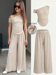 Serisse Kids Bộ đồ 2 món cho bé gái tuổi teen, bộ sưu tập mới mùa xuân hè, phù hợp cho lễ hội âm nhạc, ngày lễ Thánh Patrick, phong cách miền Tây, phong cách du mục, tiệc sinh nhật, mùa tốt nghiệp, phong cách đại học, trang phục học sinh, thường ngày, cơ bản đa năng, giải trí, kỳ nghỉ, du lịch biển, bãi biển, thời trang đường phố, phong cách đi làm - Màu be, thiết kế vai bất đối xứng, gấu áo nhún và bộ hai mảnh vải có họa tiết: áo lệch vai và quần ống rộng. - Màu be - Xem 5