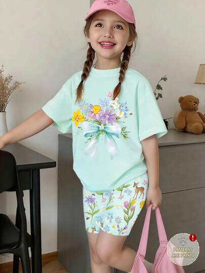 SHEIN Bộ 2 món phong cách đồng quê ngọt ngào thường ngày cho bé gái, thiết kế phổ biến, áo thun ngắn tay + quần short bó sát, họa tiết hoa và bướm nhiều màu sắc + quần short bó sát in hình hươu xanh, phù hợp cho bé gái 4-7 tuổi vào mùa xuân/hè. Áo thun in hoa và nơ xanh lá cây không chỉ dễ mặc mà còn mềm mại và thân thiện với da, giúp bé nổi bật trong mùa xuân/hè.