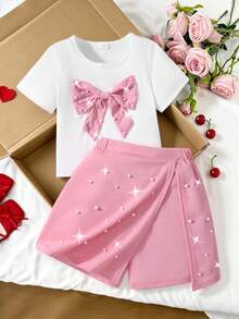 Conjunto de verano dulce y enérgico para niñas preadolescentes, camiseta de manga corta bicolor roja y blanca con gran lazo y decoración de perlas falsas + pantalones falda asimétrica, adecuado para salidas, actuaciones, citas - Rosa - Ver 1