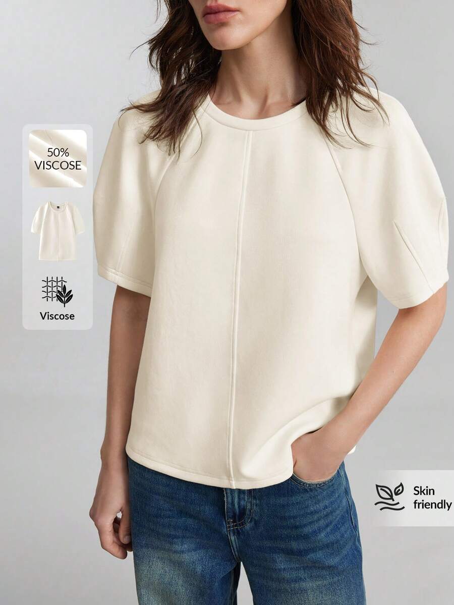 Ontre Áo thun nữ 2026SS màu mơ nhạt, chất liệu giống vải lanh, thoải mái, co giãn, cổ tròn, tay raglan, thiết kế chữ H, cổ tay nhún, điểm nhấn phối màu, phong cách hiện đại, năng động, công sở, thanh lịch, cổ điển, chất liệu cao cấp, thích hợp cho sân bay.