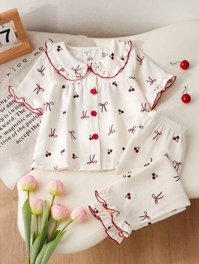 Genkimix Kids Bộ đồ ngủ cho bé gái, thoải mái và thời trang, họa tiết quả anh đào và nơ, áo tay ngắn viền bèo nhún và quần dài, 2 món.