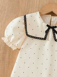 女童杏色和黑色波点印花连衣裙，配以优雅蕾丝领、荷叶边下摆、蝴蝶结装饰和泡泡袖，适合日常穿着，甜美可爱，也适合度假和夏季穿着。 - 杏色 - 查看 10
