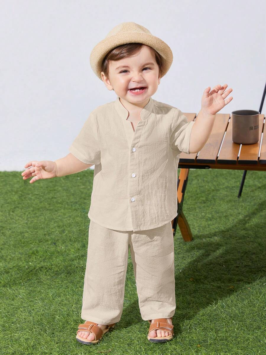 SHEIN Bộ quần áo 2 món gồm áo sơ mi và quần ngắn tay màu trơn, cổ đứng, dáng rộng, thích hợp cho bé trai và bé gái, thích hợp mặc ngoài trời, đi nghỉ mát, hàng ngày hoặc đi du lịch vào mùa xuân/hè/thu. - Màu be - Xem 1