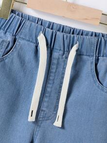 Bộ đồ thể thao cho bé trai tuổi teen mùa xuân thu 2026, màu xanh nhạt, chất liệu denim bạc màu, kiểu dáng đường phố Mỹ, áo sơ mi denim dáng rộng và quần ống côn, phong cách thường ngày cá tính cho mùa tựu trường. - Rửa trung bình - Xem 5