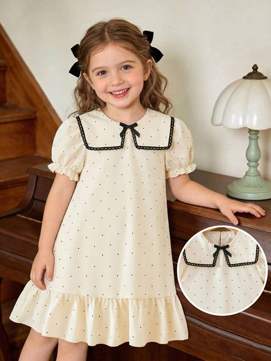 女童杏色和黑色波点印花连衣裙，配以优雅蕾丝领、荷叶边下摆、蝴蝶结装饰和泡泡袖，适合日常穿着，甜美可爱，也适合度假和夏季穿着。 - 杏色 - 查看 1