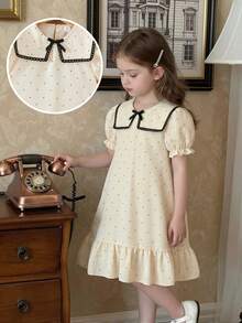 女童杏色和黑色波点印花连衣裙，配以优雅蕾丝领、荷叶边下摆、蝴蝶结装饰和泡泡袖，适合日常穿着，甜美可爱，也适合度假和夏季穿着。 - 杏色 - 查看 5