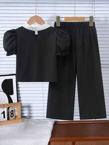 Genkimix Kids Bộ đồ thời trang cho bé gái gồm áo kiểu tay cánh hoa đính nơ, cổ tròn và quần dài thoải mái. - Nhiều màu - Xem 2
