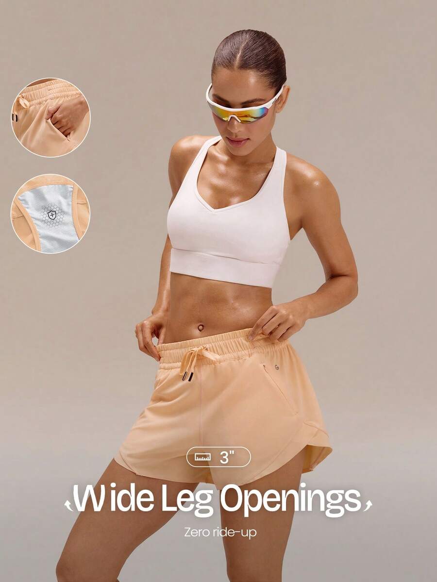 GLOWMODE Quần short VitalSwift Sleek Strides 3 inch, nhẹ, nhanh khô, co giãn, khử mùi, xẻ tà bên hông, túi khóa kéo, thích hợp cho tập luyện tennis, chạy bộ, thể dục, tập gym. - trái cam - Xem 1