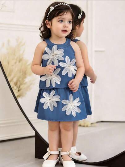 Souflis Souflis Conjunto de 2 piezas para niñas bebé: top de tirantes con flores 3D y falda evasé. Los detalles florales 3D añaden un encanto sin fin. El diseño a medida es tanto favorecedora como cómoda. El top de tirantes combinado con la falda evasé muestra la dulzura y la vitalidad de una niña pequeña. Ya sea en un evento deportivo con energía sin límites o en una fiesta con familiares y amigos, el bebé puede ser el centro de atención. Versátil para diversas ocasiones.