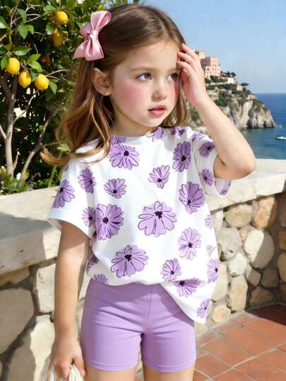 Bộ 2 món thời trang thường ngày đa năng cho bé gái mùa xuân/hè, gồm áo thun in hoa màu tím dễ thương và quần short tím thoải mái, lý tưởng cho các hoạt động ngoài trời mùa xuân và mùa hè.