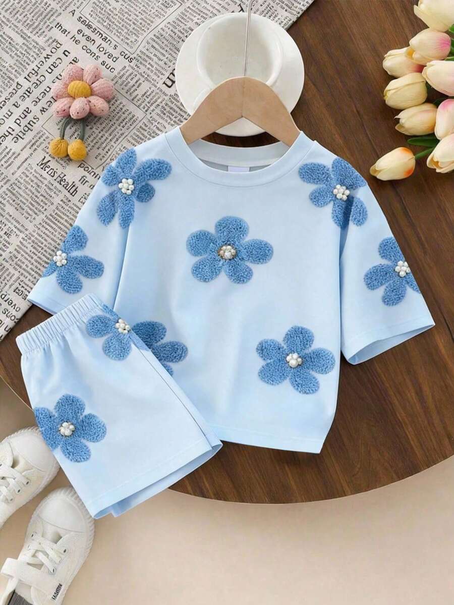 SHEIN Bộ đồ cho bé gái tuổi teen, gồm áo thun ngắn tay và quần short in hoa, kiểu dáng thoải mái, thời trang, dễ thương, thích hợp cho mùa xuân đến hè, màu xanh nhạt tươi mát. - Nhiều màu - Xem 1