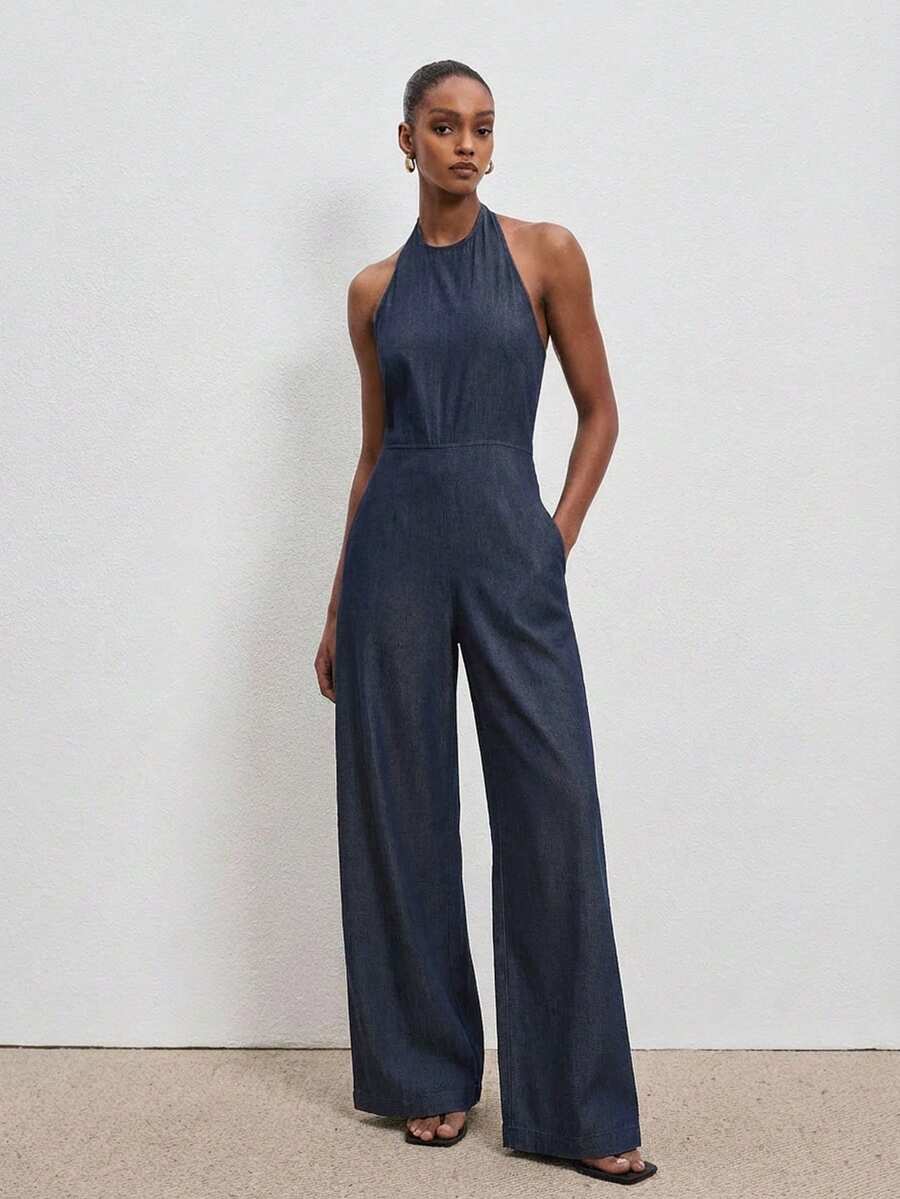 ATUI Studio Women's Casual Sexy Backless Halter Neck Denim Jumpsuit With Side Pockets, Suitable For Summer Vacation - Navy Blue - View 1