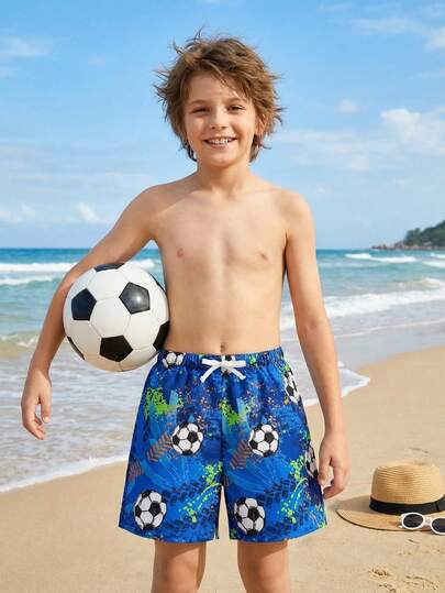 SHEIN Quần short đi biển dáng rộng in hình quả bóng đá, trang trí nơ, dành cho bé trai tuổi teen.