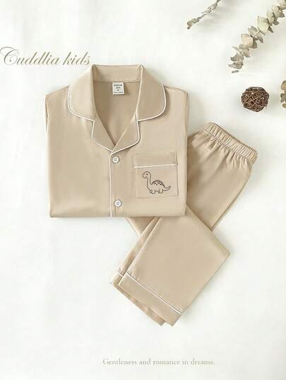 Bộ đồ ngủ 2 món cho bé trai màu xanh hải quân trơn, áo tay ngắn và quần dài, thích hợp cho mùa hè.