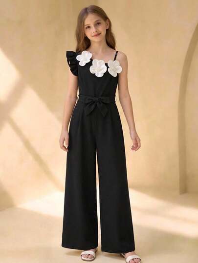 这款少女法式极简主义不对称肩部连体裤，采用系带腰身和阔腿设计，时尚别致。不对称的肩部领口设计，点缀着优雅的白色山茶花和仿珍珠纽扣，尽显精致优雅。无袖吊带、系带腰身和阔腿裤型，更添几分时尚气息。专为追求奢华美感的都市女性打造，适合春夏度假、约会或鸡尾酒会等场合。黑色底色衬托出立体感十足的白色山茶花，修身剪裁更显身材曲线。