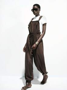 Lumivelle Tuta aderente da donna di colore unito con spalline larghe, laccio in vita, schiena aperta, tasche reali, aperture a zampa di elefante, fiocco, gamba a lanterna, pantaloni casual ed eleganti per primavera, estate, autunno - Castano - Visualizzare 6