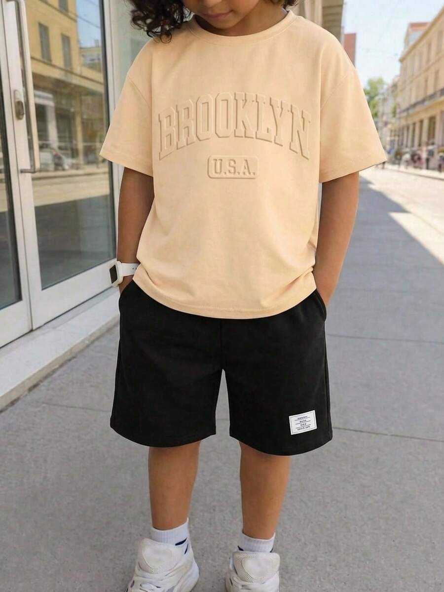 SHEIN 2pcs Tween Boy Casual Sports Loose Fit Embossed Letter Graphic Round Neck Short Sleeve T-Shirt And Elastic Waist Shorts Set, Suitable For Commuting, School, Daily Casual, Sports, Spring/Summer - Khaki - View 1