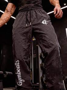 GymBeat Pantalones de chándal holgados con cordón en la cintura y estampado de letras para hombre - Gris - Ver 1
