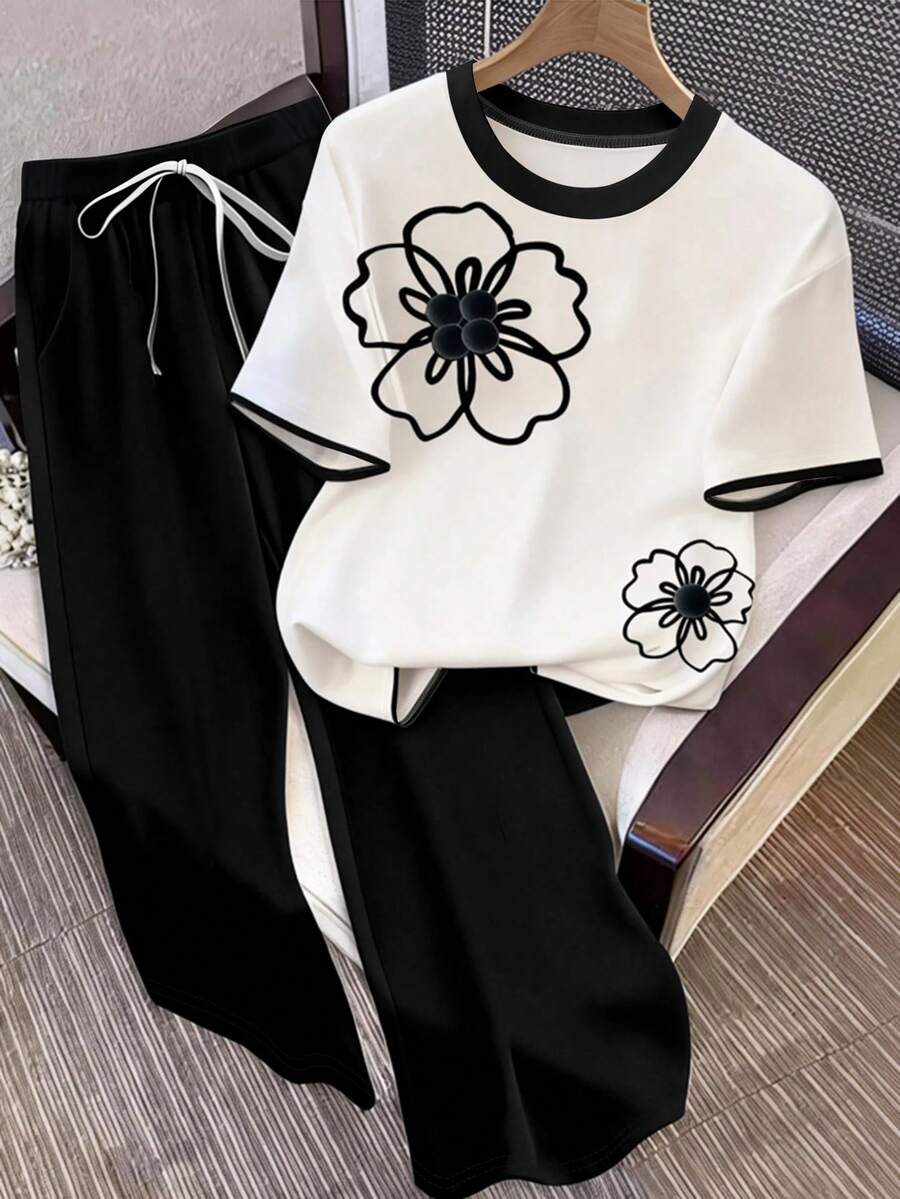 GlowEve CURVE Plus Size 2-Piece Set: Contrast Color Short Sleeve T-Shirt With Contrast Trim And Button Detail, Paired With Elegant Straight Leg Slim Fit Pants - Black and White - View 1