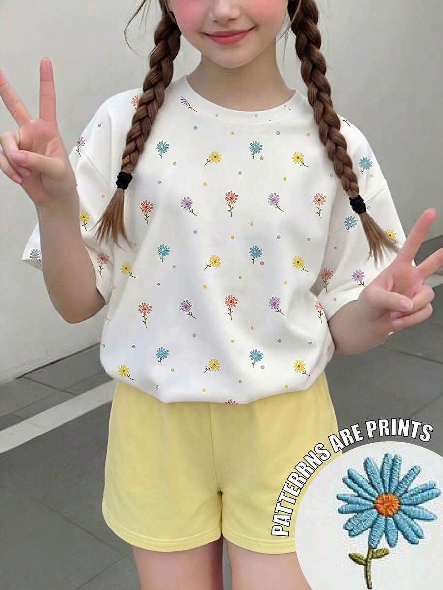 少女彩色花卉印花图案T恤套装，白色宽松圆领短袖T恤搭配黄色短裤，两件套，夏季设计，百搭基础款，适合户外休闲穿着，舒适柔软。圆领T恤和短裤套装，适合春夏日常、居家、度假、节日等场合，充满春日气息，清爽宜人。春夏外出穿搭，轻松舒适，时尚少女套装，休闲服饰，花卉图案服装，春夏套装，新款，清凉舒适，春日清爽，夏日假期必备。 - 彩色 - 查看 1