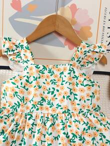 Vintaside Kids 清新可爱的女童连衣裙：白色底布上印有橙色花朵和绿色枝条，柔和的色调展现活力；方领搭配荷叶袖，俏皮又显肩部线条；双层荷叶边裙摆，蓬松轻盈，行走间更显动感。透气面料，甜美可爱，是春夏的理想之选。 - 黃色 - 查看 8