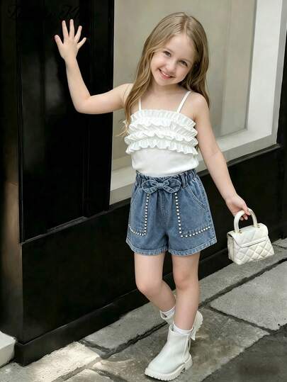 Elladie kids 2件套夏季女童休闲优雅可爱荷叶边白色吊带背心+腰间蝴蝶结装饰+口袋珍珠牛仔短裤套装，适合日常、通勤、休闲、运动。