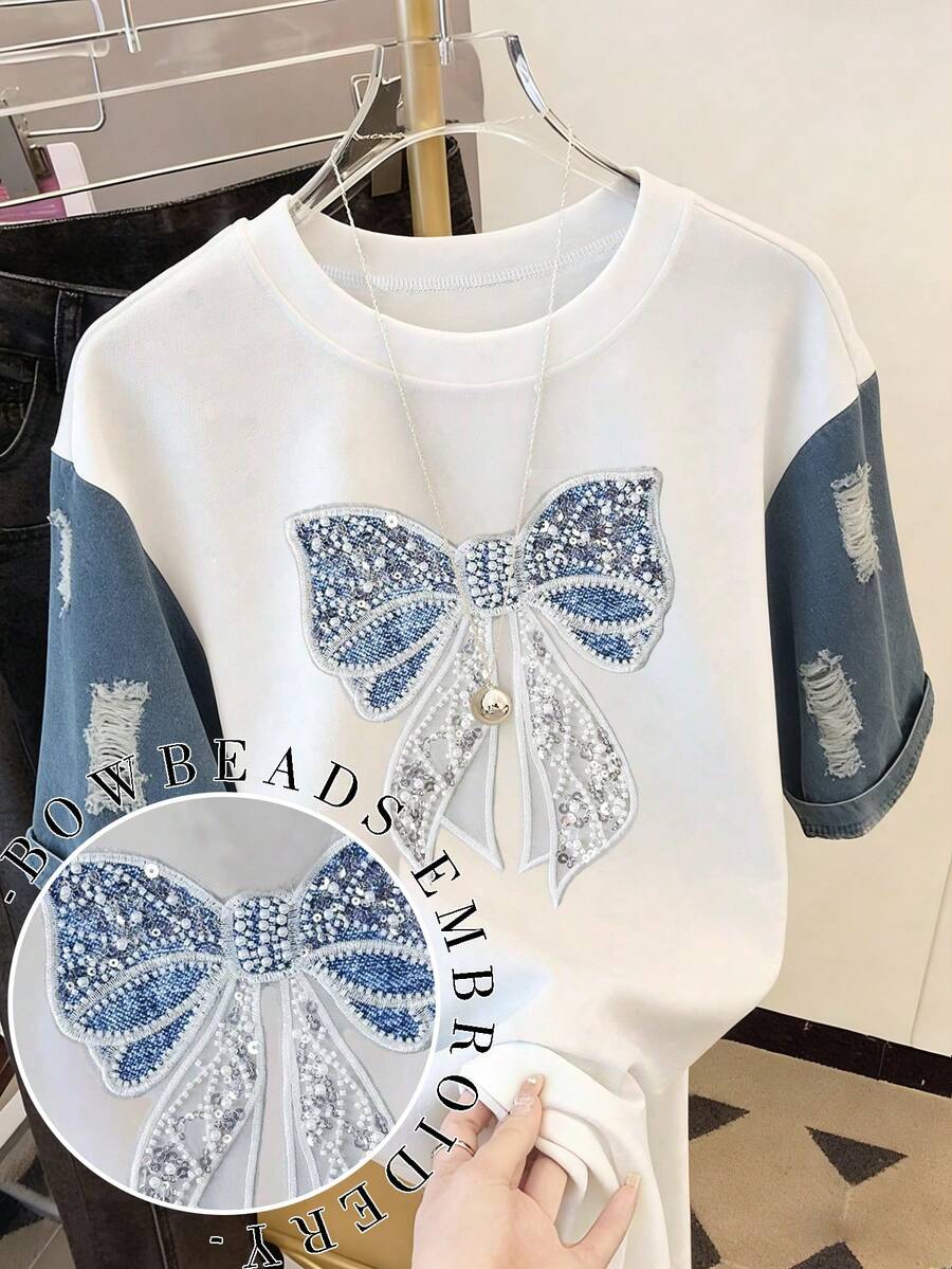 Resyla Áo thun nữ thời trang thường ngày cổ tròn vai rớt, chất liệu giả denim phối nhiều mảng, áo thun phối nhiều mảng thêu nơ ngọc trai, áo thun nơ, áo thun ngọc trai, áo thun phối nhiều mảng, áo thun thường ngày thoải mái mặc ngoài trời, áo thun bốn mùa, áo thun giả denim. - trắng - Xem 1