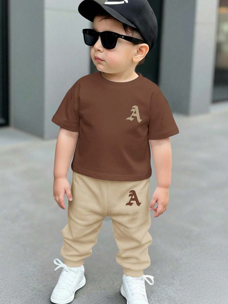 SHEIN Bộ đồ thể thao thoải mái, rộng rãi, cổ tròn, tay ngắn và quần dài cho bé trai, hàng mới về mùa thu. - Nhiều màu - Xem 1
