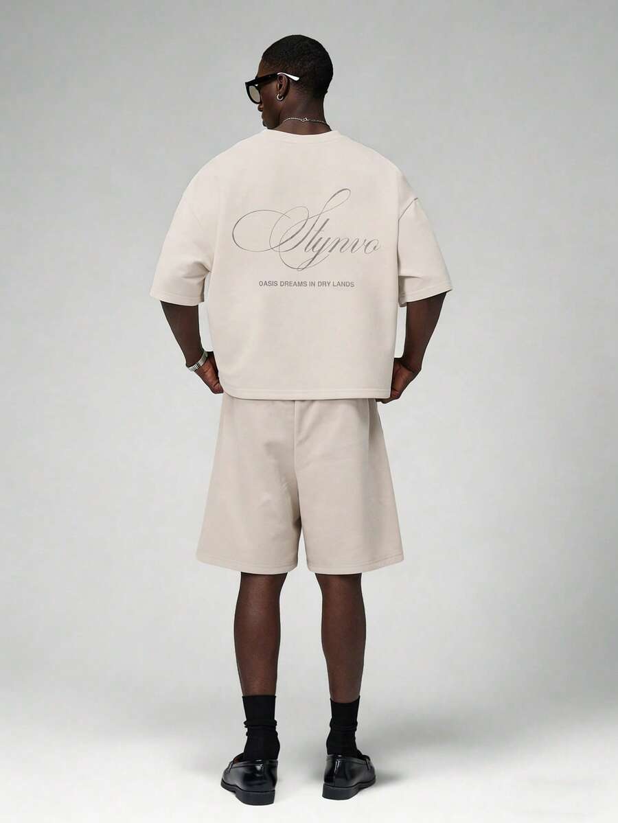 STYNVO Bộ áo thun cổ tròn in chữ và quần short rộng dành cho nam. - Màu be - Xem 1