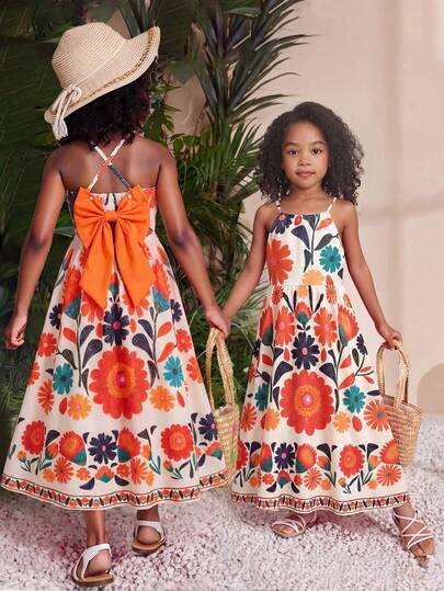 Đầm Dopamine màu đỏ, kiểu dáng mùa hè mới, dây mảnh, hở lưng, đính nơ, không tay, dáng chữ A, chất liệu vải có họa tiết, chất liệu mềm mại, thoải mái.