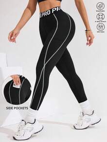 Easithlete Leggings de activewear negro para mujer con cintura en bloque de color, rayas e impresión de lema deportivo, longitud 3/4, adecuado para uso diario casual, correr, pilates, yoga, gimnasio, tenis. Ropa de otoño para mujer. Leggings de activewear con bolsillos, leggings de entrenamiento, leggings de gimnasio, leggings deportivos, leggings negros, leggings para mujer - Negro - Ver 1
