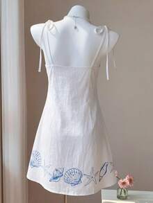 Comfortcana Đầm ngắn hai dây thắt nơ màu trơn họa tiết sinh vật biển, chất liệu cotton mềm mại, thích hợp cho kỳ nghỉ biển/lễ hội âm nhạc/đi làm hàng ngày/thời gian rảnh ở nhà/trang phục thoải mái. - trắng - Xem 2