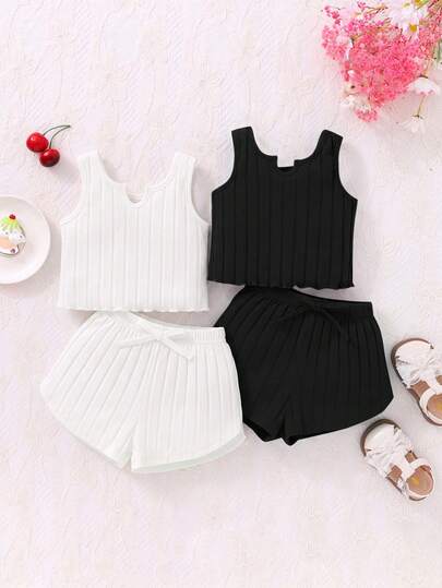 Bộ 4 món cho bé gái, gồm áo hai dây dệt kim màu trơn và quần short cạp chun.