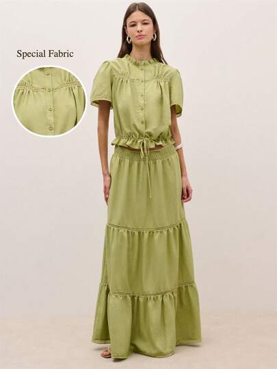 Nöista Bộ áo và chân váy, được thiết kế với cổ áo đứng xếp nếp và tay áo phồng ngắn. Áo có hàng cúc phía trước, eo có dây rút điều chỉnh và đường may xếp ly giúp dễ dàng vận động. Thích hợp cho trang phục mùa hè, mùa xuân, kỳ nghỉ, lễ hội âm nhạc, đi biển. Phối đồ đồng bộ.