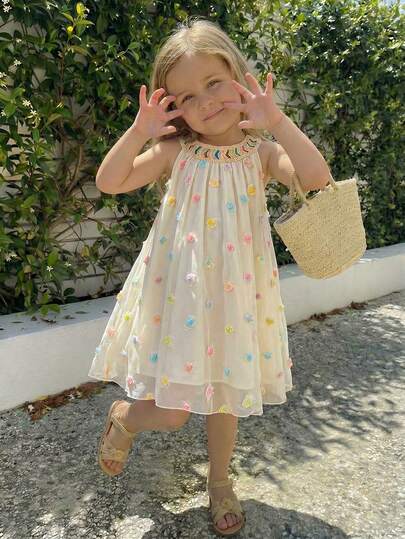 A Gentle Cream-White Summer Dress For Girls, Crafted From Selected Lightweight And Soft High-Density Mesh Fabric That Is Skin-Friendly, Breathable, And Has An Excellent Drape With A Natural Translucent Soft-Glow Texture. Featuring A Halter Neck Design With A Rainbow Woven Neckline And The Skirt Body Adorned With Colorful 3D Floral Decorations, The Loose A-Line Silhouette Exudes A Relaxed And Sweet Vibe. This Stylish 'Old Money' Summer Piece Is Perfect For Various Occasions Such As Beach Weekends