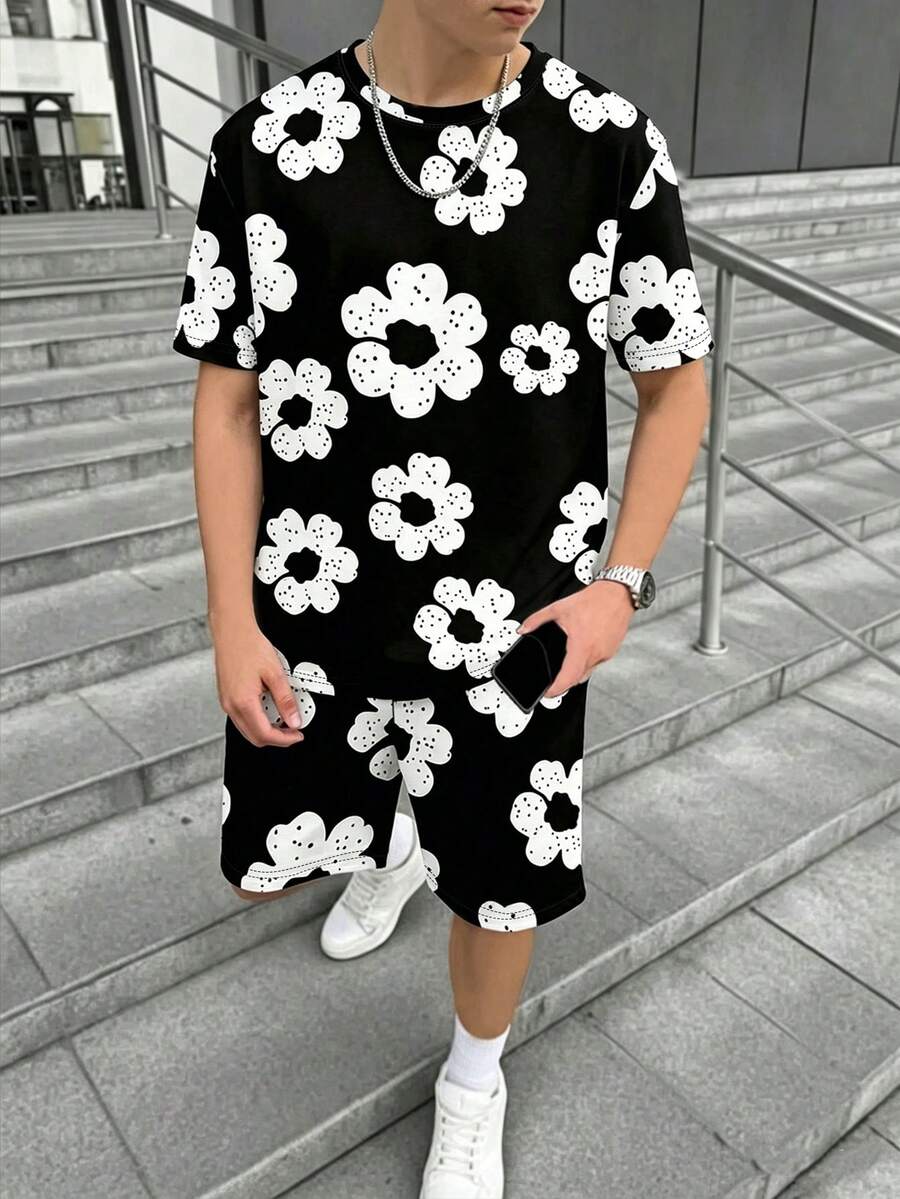 两件套休闲印花青少年男童套装,黑色T恤搭配白色花朵图案短裤,适合春夏日常穿着、旅行和轻度运动。 - 彩色 - 查看 1