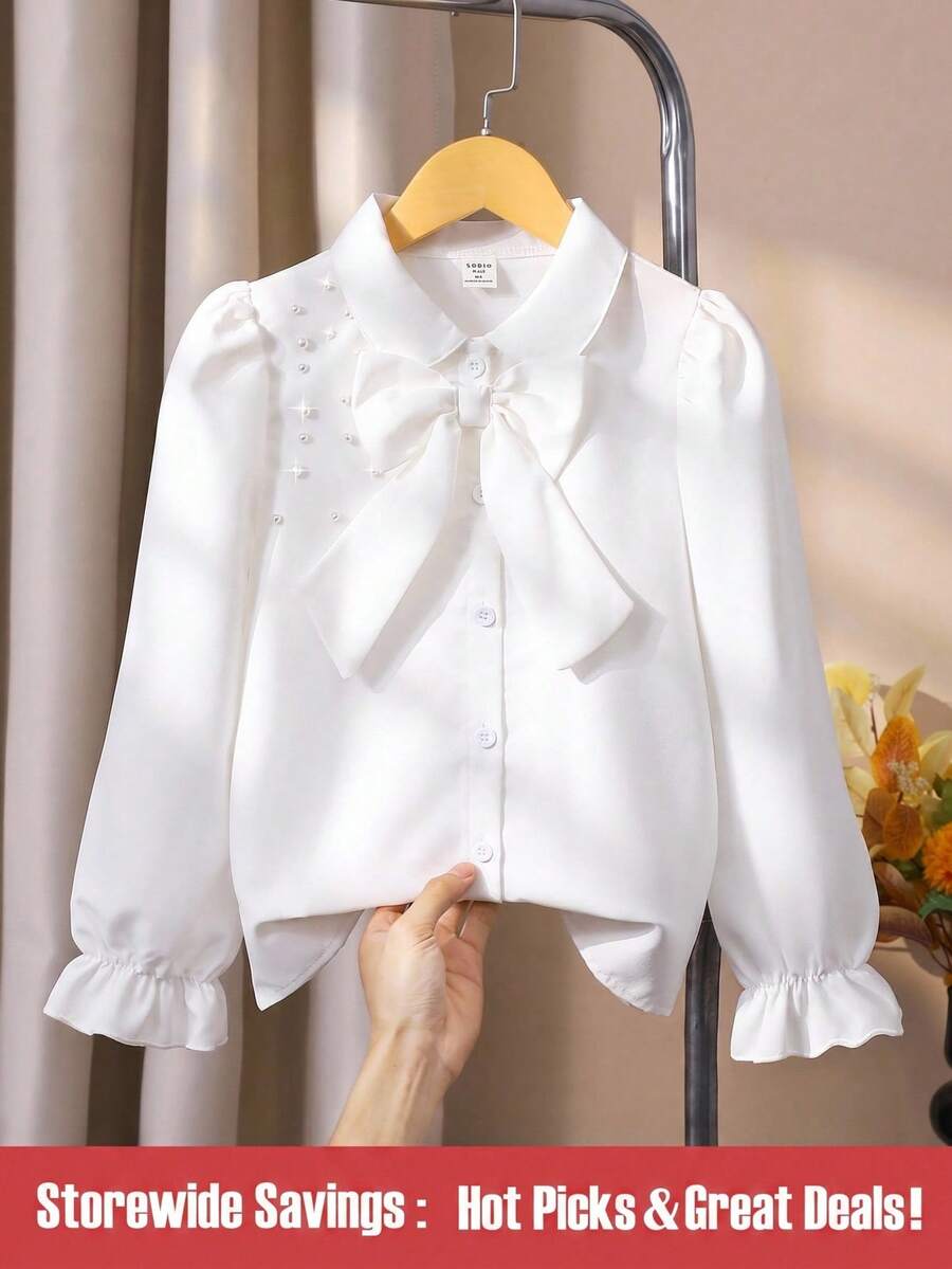 SHEIN 女童荷叶边长袖衬衫，春秋季款，肩部饰有可拆卸蝴蝶结，宽松版型，活力十足，面料舒适，可搭配背带裙叠穿或单穿。 - 白色 - 查看 1