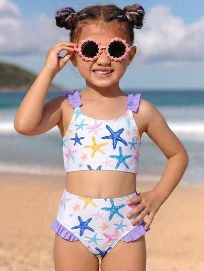 SHEIN Young Girls Tankinis 2-Piece Swimsuit Set, Fresh Ocean Style. Pure White Base With Printed Blue, Yellow And Pink Starfish Pattern, Exuding Summer Ocean Vibe; Paired With Lavender Ruffle Trim On Shoulder Straps And Shorts Hem. Knit Fabric, Sleeveless Swimsuit Set, Fashionable, Elegant And Suitable For Swimming, Summer Vacation, Beach, Pool, Holiday Party