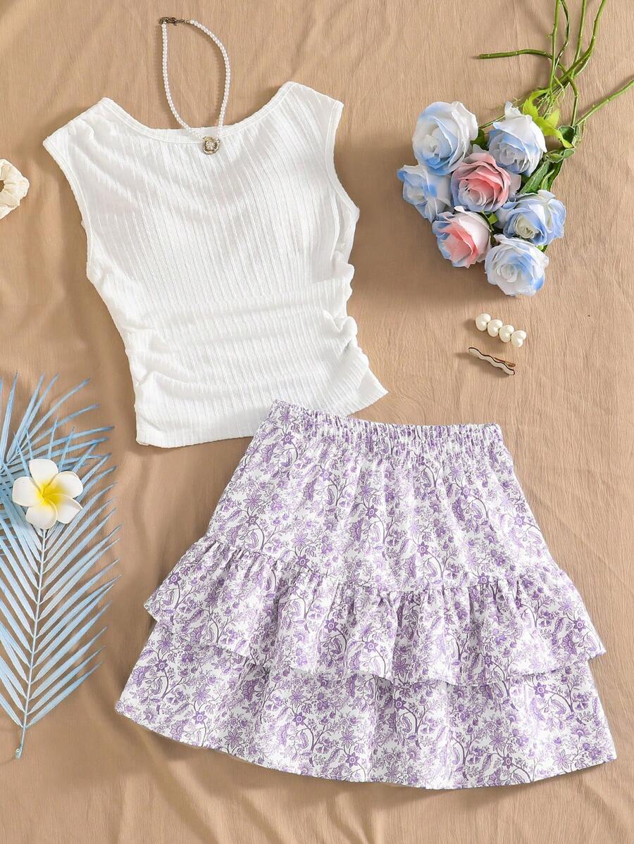 SHEIN Sparklyn Bộ đồ hai mảnh mới dành cho nữ tuổi teen này gồm áo vest cổ tròn màu xanh dương co giãn, thoải mái, mang phong cách nghỉ dưỡng, kết hợp với chân váy hai tầng cùng màu. Phần eo và gấu áo vest được xếp ly tạo nên vẻ ngoài thanh lịch. Bộ đồ chất lượng cao này hoàn hảo cho trang phục hàng ngày, bao gồm cả các kỳ nghỉ, du lịch và tiệc tùng, lý tưởng cho mùa xuân và mùa hè. - Nhiều màu - Xem 1