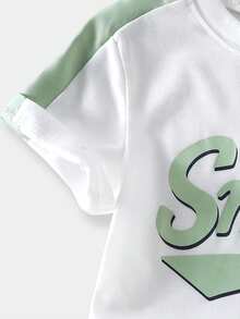SHEIN Casuvi Kids Bộ 2 món cho bé gái: Áo thun tay ngắn cổ tròn dáng rộng phối màu tương phản kiểu retro in chữ Mỹ dễ thương + Quần cargo màu xanh nhạt, trang phục thời trang mùa hè thích hợp ở nhà, du lịch, thể thao, hoạt động ngoài trời và mặc hàng ngày. - Màu xanh Bạc hà - Xem 6