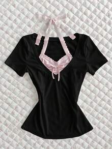 Flirla Camiseta ajustada de manga corta con volantes, parches de color contrastante y lazo, de estilo estriado blanco. Prenda versátil y elegante para uso diario, oficina y viajes, ideal para primavera/verano - Negro - Ver 1