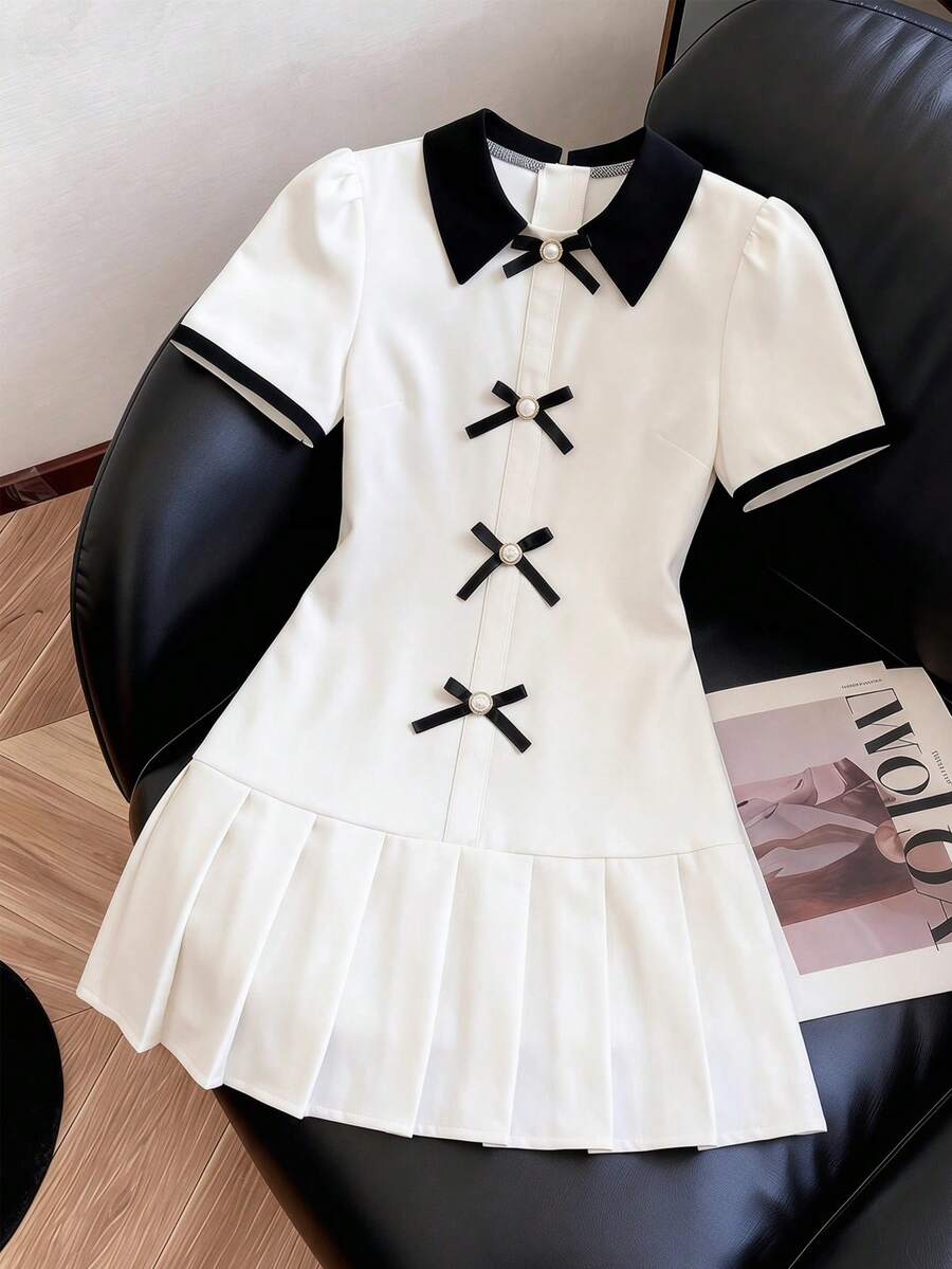 Elladie kids Đầm bé gái tuổi teen mùa hè 2026 mới, chất liệu vải trắng phối cổ và tay áo đen, eo có dây rút, gấu váy xếp ly, trang trí nơ, kiểu dáng tối giản, thoải mái, dáng rộng, ngọt ngào, phong cách preppy. - trắng - Xem 1