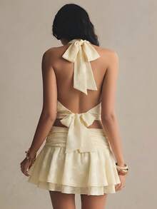 Poéselle Women's Ivory Jacquard Halter Bow-Tie Backless Blouson Top – Elegant High-Neck Summer Party Crop Halter Neck Top Backless Blouse Bow Tie Back Top Ivory Crop Top Elegant Summer Top Draped Halter Blouse Party Outfit Women Romantic Fashion Solid Color Halter Tie Backless Sexy Versatile Blouse For Dates & Outings Easter Outfits Festival Outfits Wedding Country Concert Outfit Yellow Top - Pale Yellow - View 3
