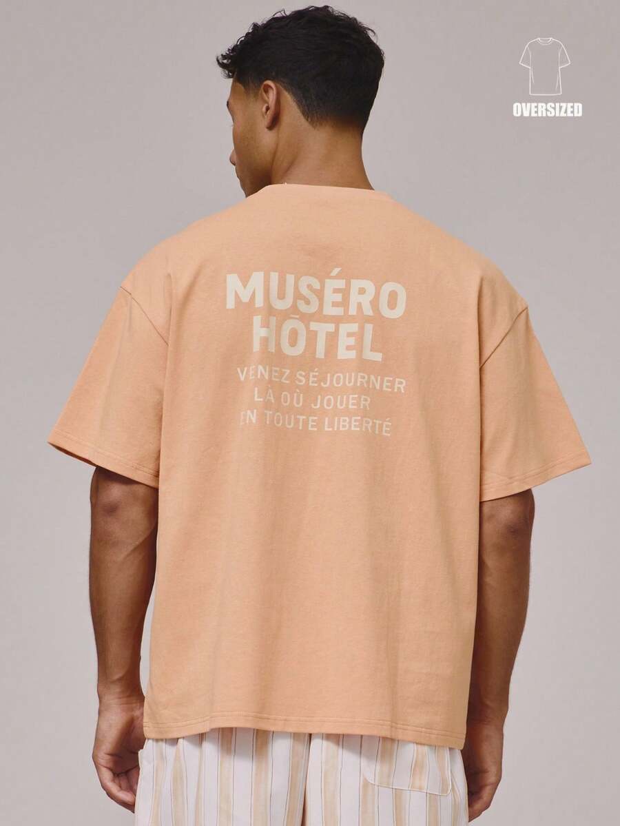 Camiseta de manga corta oversize con gran estampado gráfico con eslogan "MUSERO HOTEL" en la espalda, esencial para vacaciones de primavera y verano - Naranja - Ver 1